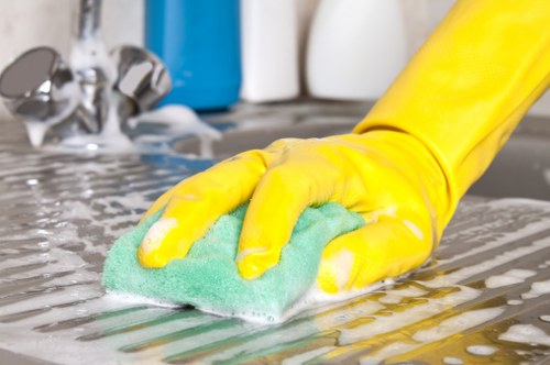 Professional domestic cleaner working in a Hackney kitchen
